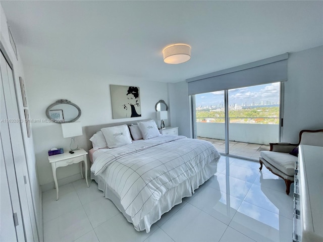 bedroom featuring light tile patterned floors and access to exterior