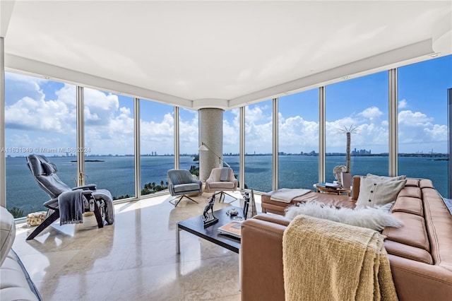 sunroom / solarium featuring a water view and a healthy amount of sunlight