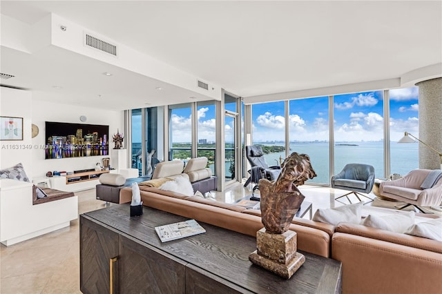 tiled living room featuring a water view and floor to ceiling windows