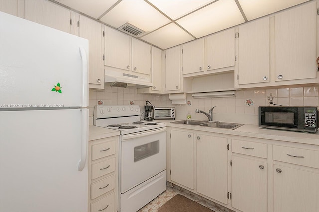 kitchen with tasteful backsplash, sink, white appliances, and light tile patterned floors