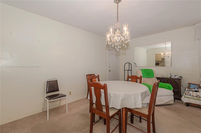 dining area with a notable chandelier and light colored carpet