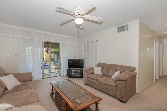 living room featuring light carpet and ceiling fan