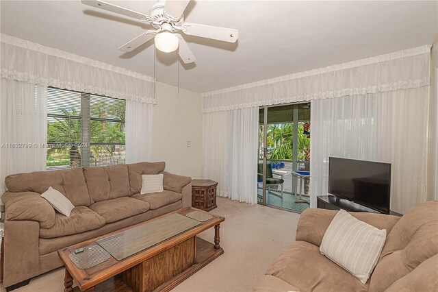 living room with a healthy amount of sunlight, light colored carpet, and ceiling fan