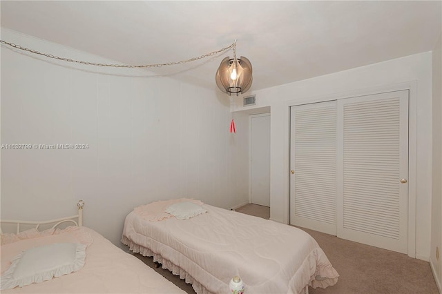 carpeted bedroom with a closet