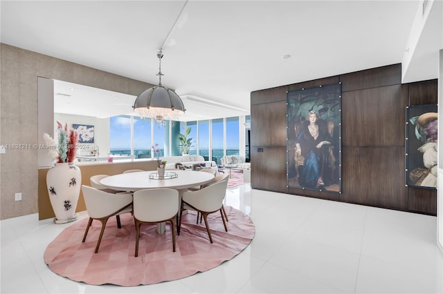 tiled dining space featuring a notable chandelier