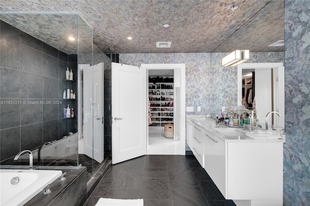 bathroom featuring vanity, tile walls, and plus walk in shower