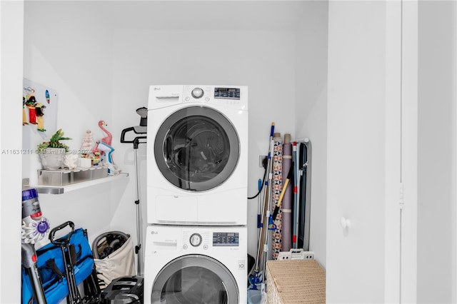 clothes washing area with stacked washer and clothes dryer