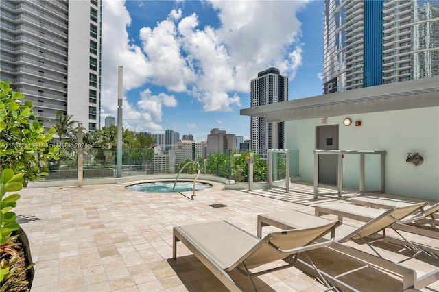 view of pool with a hot tub and a patio area