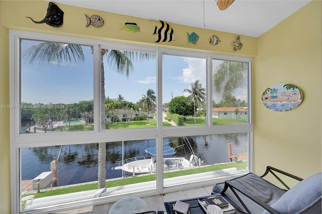 interior space featuring ceiling fan and a water view