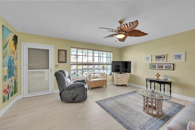 living room with light hardwood / wood-style floors and ceiling fan