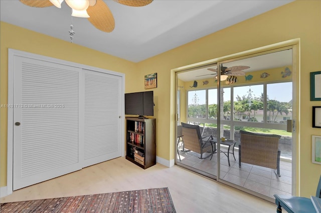 sitting room featuring ceiling fan, wood finished floors, and baseboards