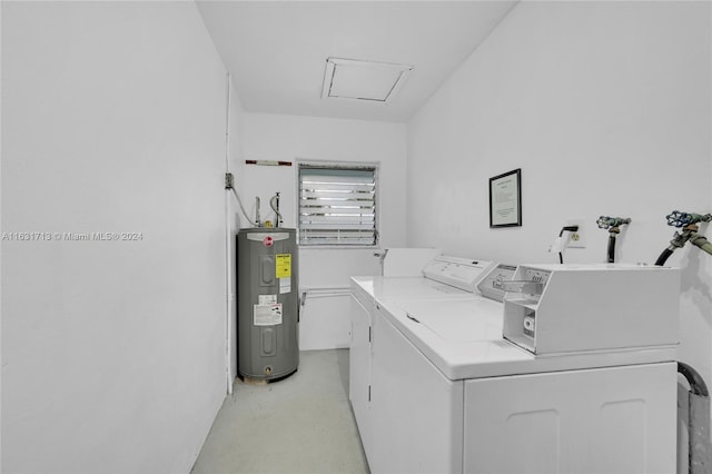 clothes washing area featuring washing machine and clothes dryer and water heater