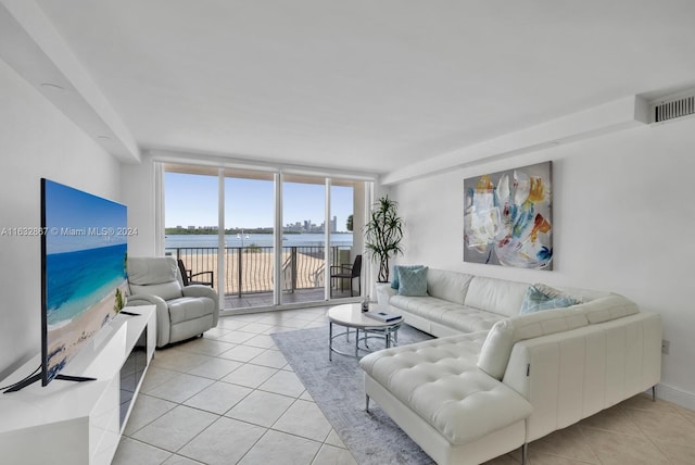 living room with light tile patterned floors and floor to ceiling windows