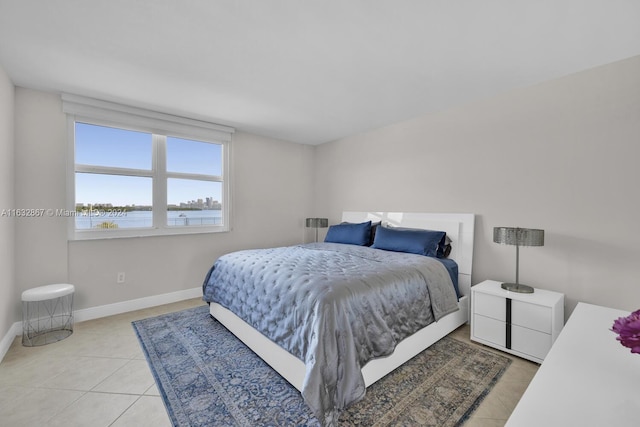 tiled bedroom featuring a water view