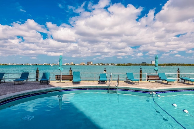 view of pool with a water view