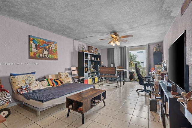 living room with light tile patterned floors, a textured ceiling, and ceiling fan