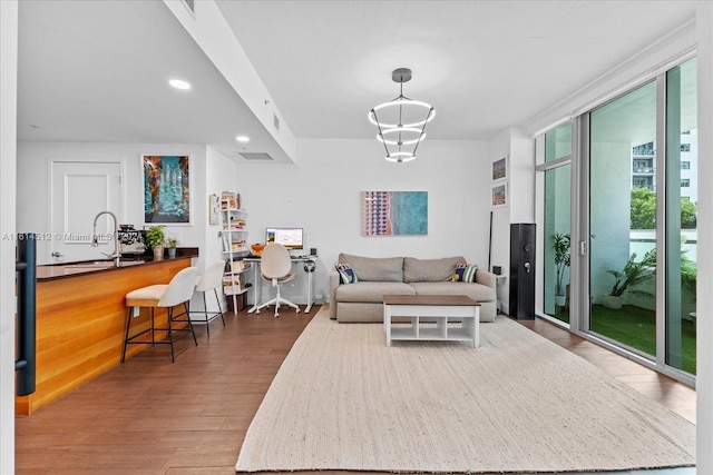 living room with hardwood / wood-style flooring and sink