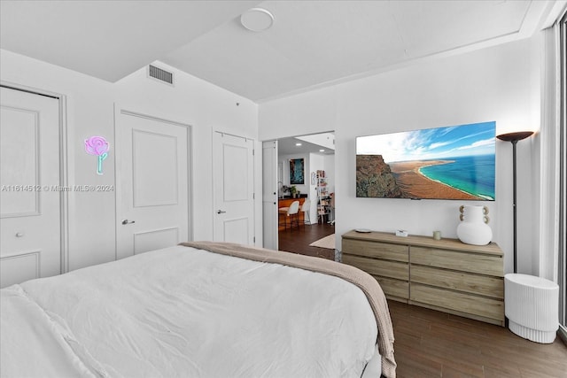 bedroom with dark wood-type flooring