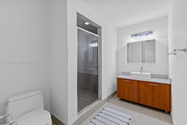 bathroom featuring walk in shower, tile patterned floors, toilet, and vanity