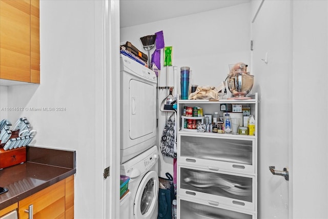 clothes washing area with stacked washer and clothes dryer