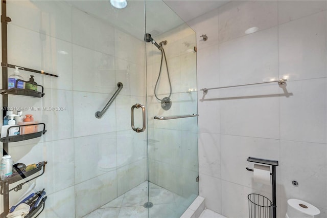 bathroom with tile walls and walk in shower