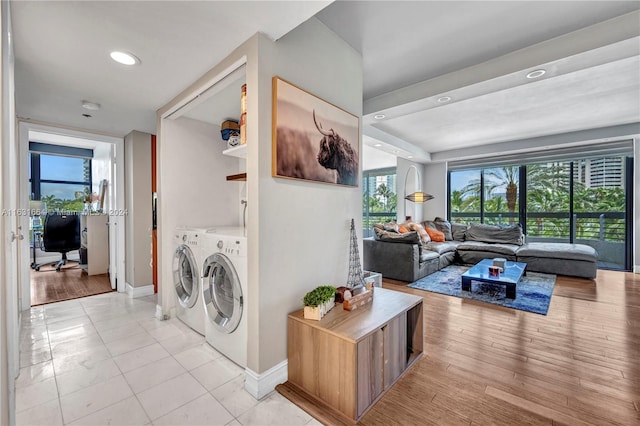 washroom featuring light hardwood / wood-style floors and washing machine and clothes dryer