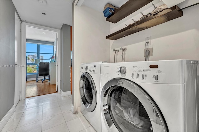 washroom with washing machine and dryer and light tile patterned floors