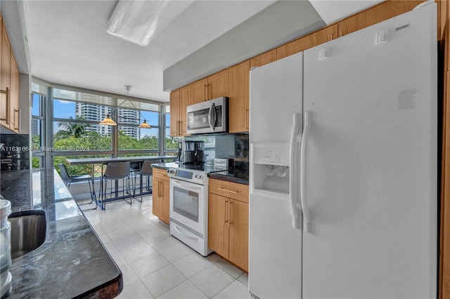 kitchen featuring hanging light fixtures, light brown cabinetry, white appliances, light tile patterned flooring, and floor to ceiling windows