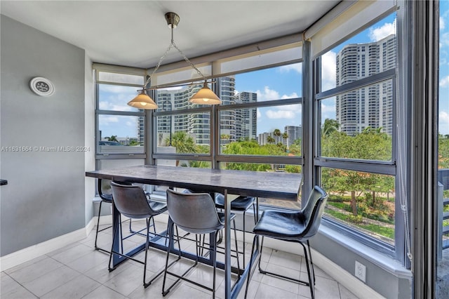 tiled dining room featuring a wealth of natural light