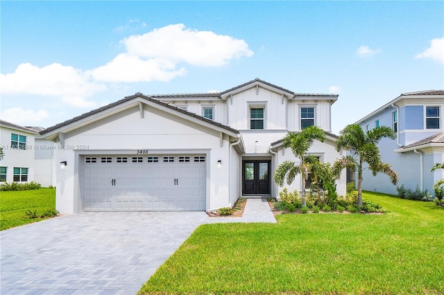 view of front of home with a garage and a front yard