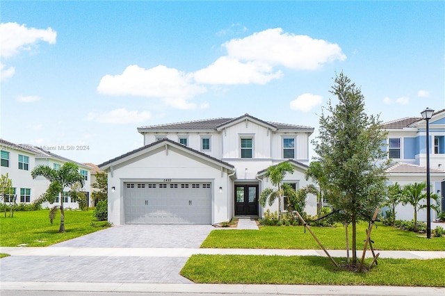 view of front of home with a garage and a front lawn