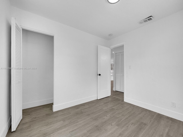 unfurnished bedroom featuring hardwood / wood-style floors