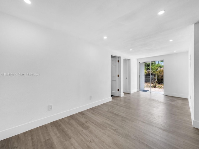 empty room with hardwood / wood-style floors