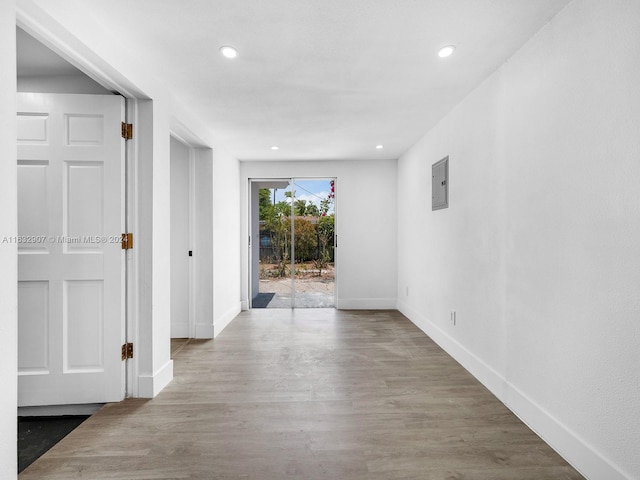 hallway featuring wood-type flooring and electric panel