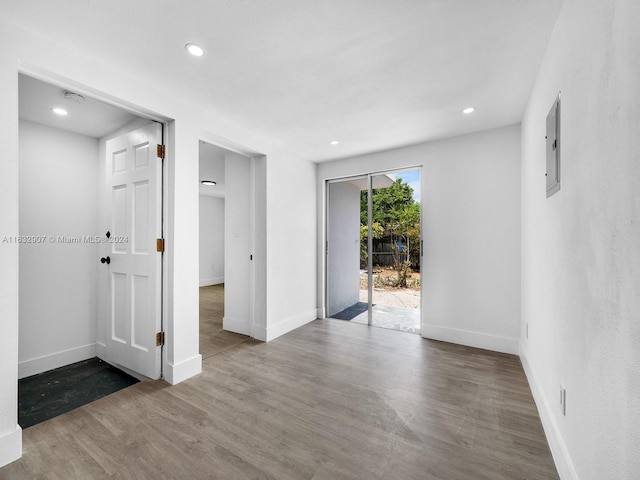 unfurnished room featuring hardwood / wood-style flooring and electric panel