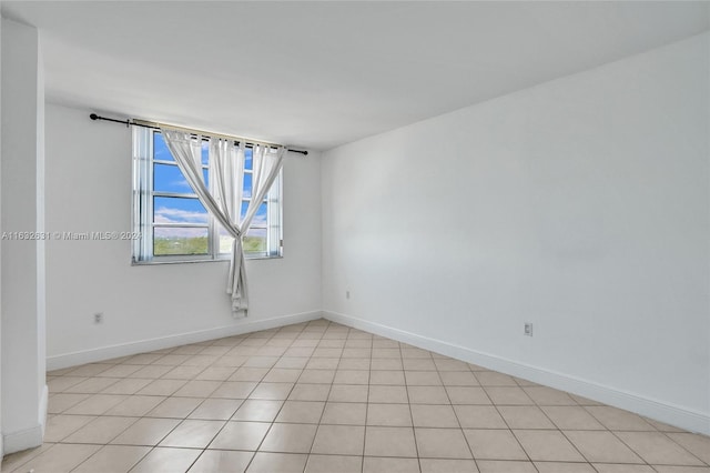 unfurnished room featuring light tile patterned floors