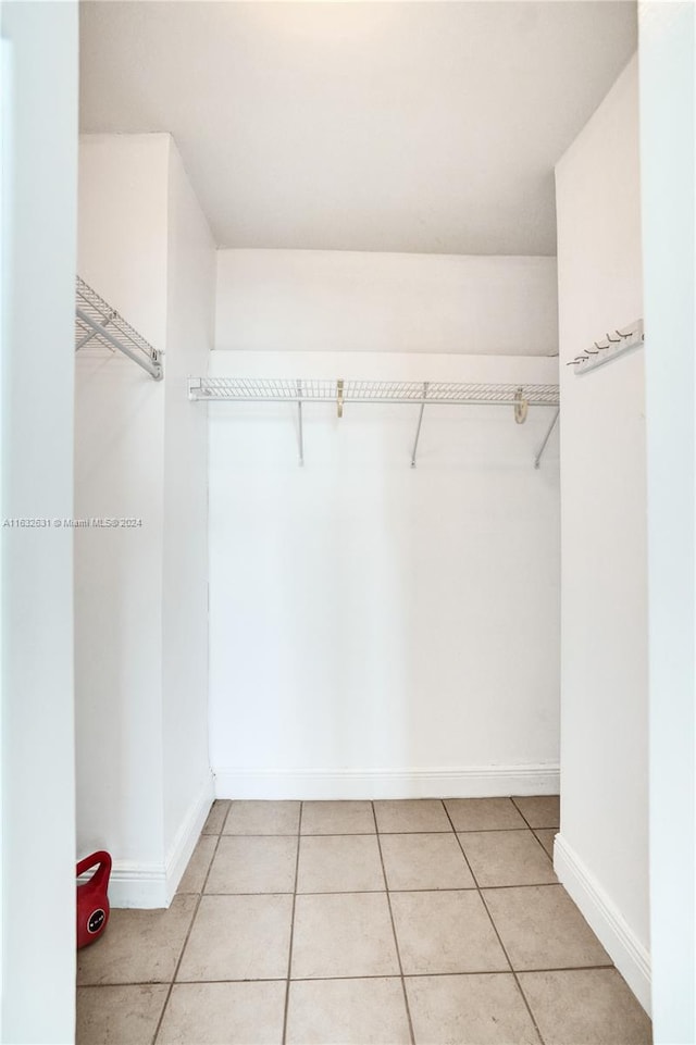 spacious closet featuring light tile patterned floors