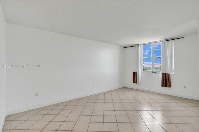 spare room with light tile patterned floors