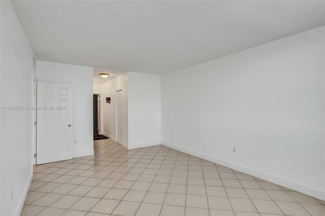 empty room with light tile patterned flooring