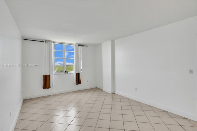 spare room featuring light tile patterned floors