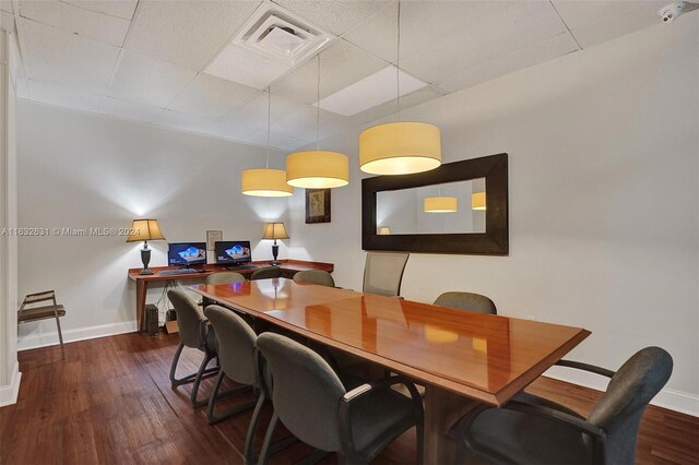 dining area featuring hardwood / wood-style flooring and a paneled ceiling