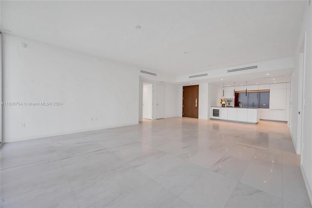 unfurnished living room featuring light tile patterned floors