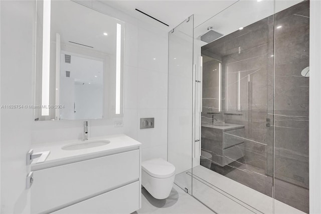 bathroom with a shower with shower door, vanity, tile patterned floors, and toilet