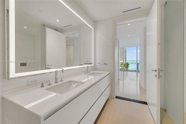 bathroom with tile patterned flooring and double vanity