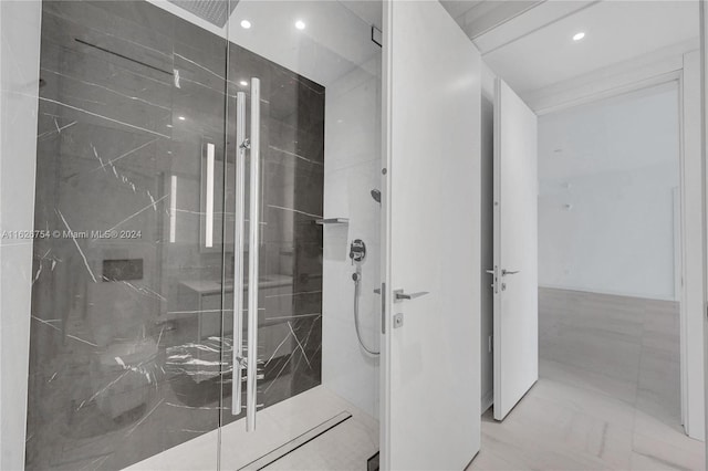 bathroom featuring a shower with shower door and tile patterned floors