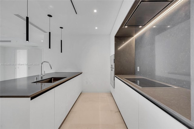 kitchen with light tile patterned flooring, white cabinetry, hanging light fixtures, and sink