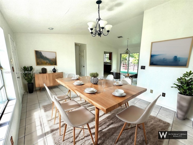 dining room featuring vaulted ceiling, light tile patterned flooring, visible vents, and a notable chandelier