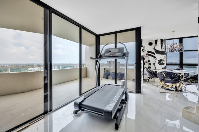 workout room with floor to ceiling windows and light tile patterned flooring