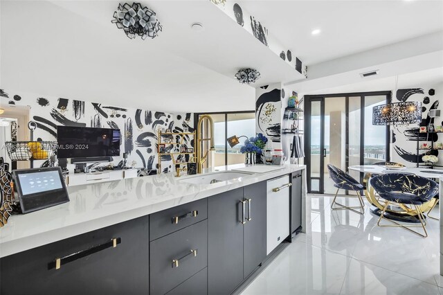 kitchen featuring sink, light stone counters, light tile patterned flooring, and dishwasher