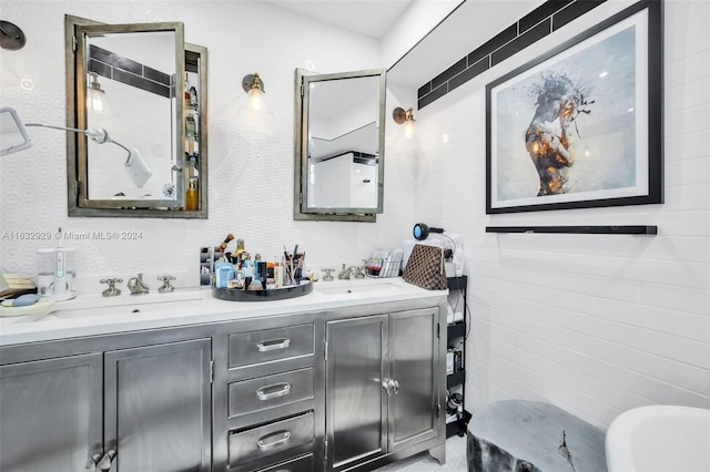 bathroom featuring vanity and tile walls